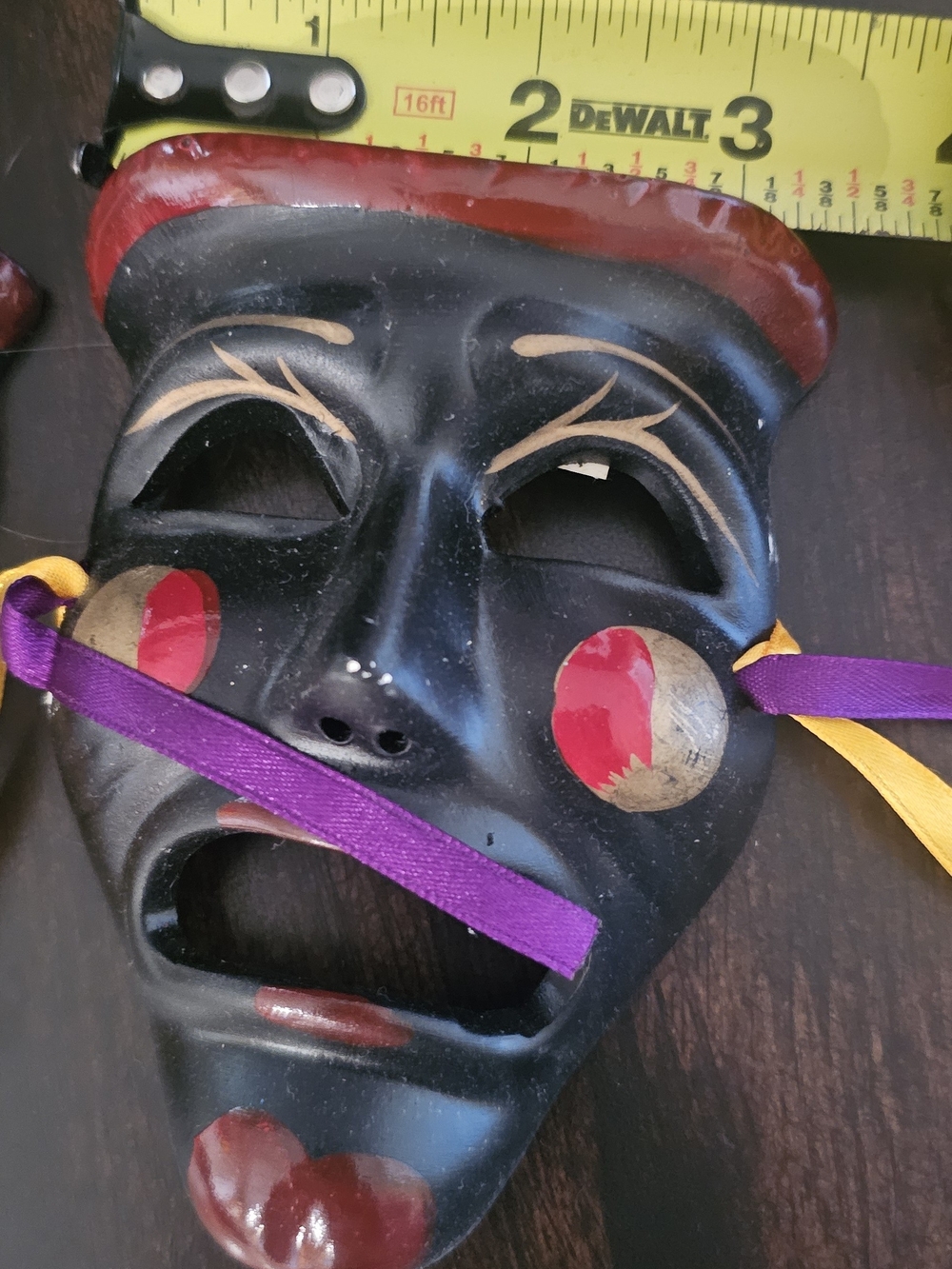 Decorative Black Carnival Mask with Red and Gold Accents